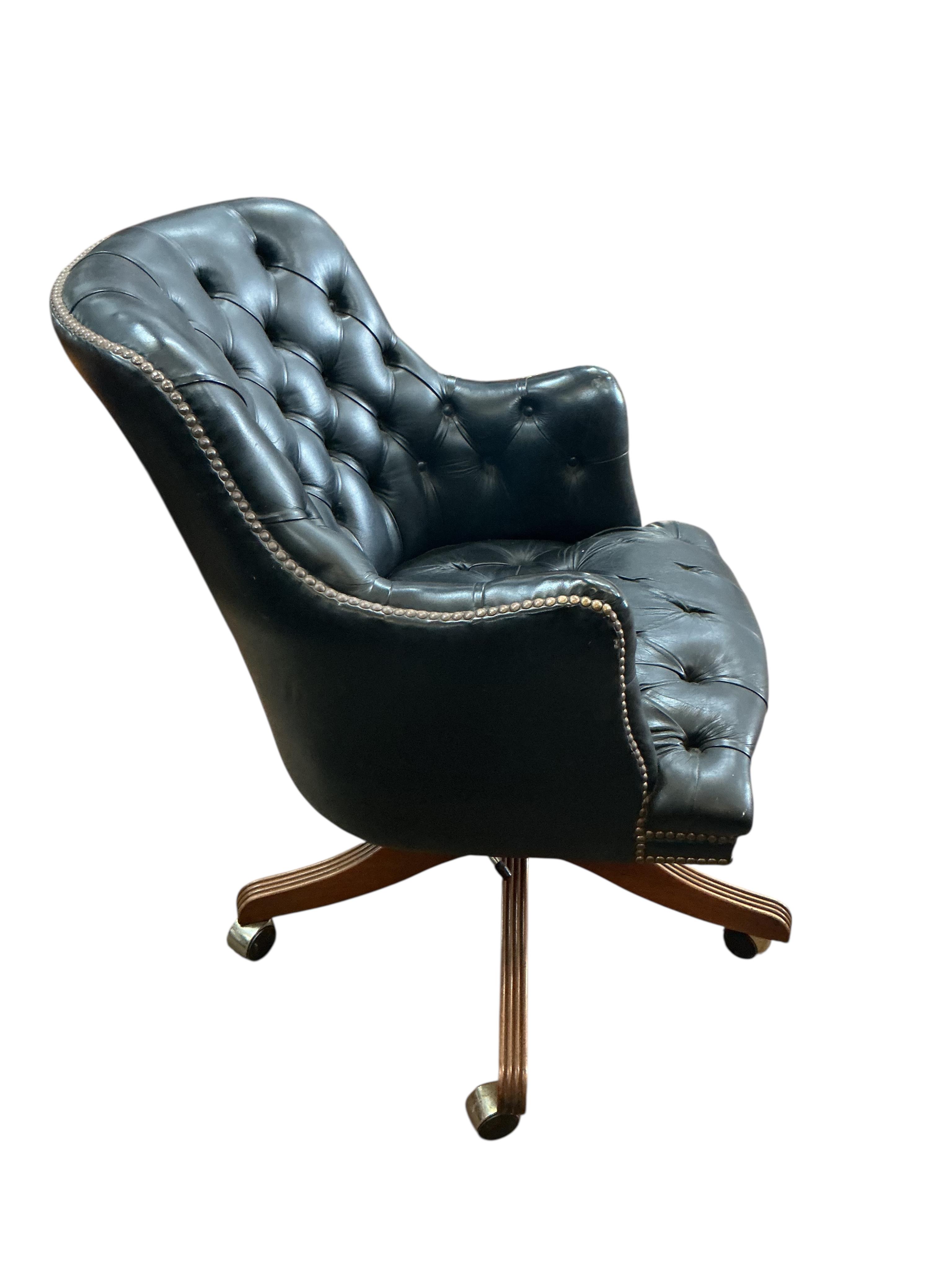 A buttoned leather swivel desk chair
